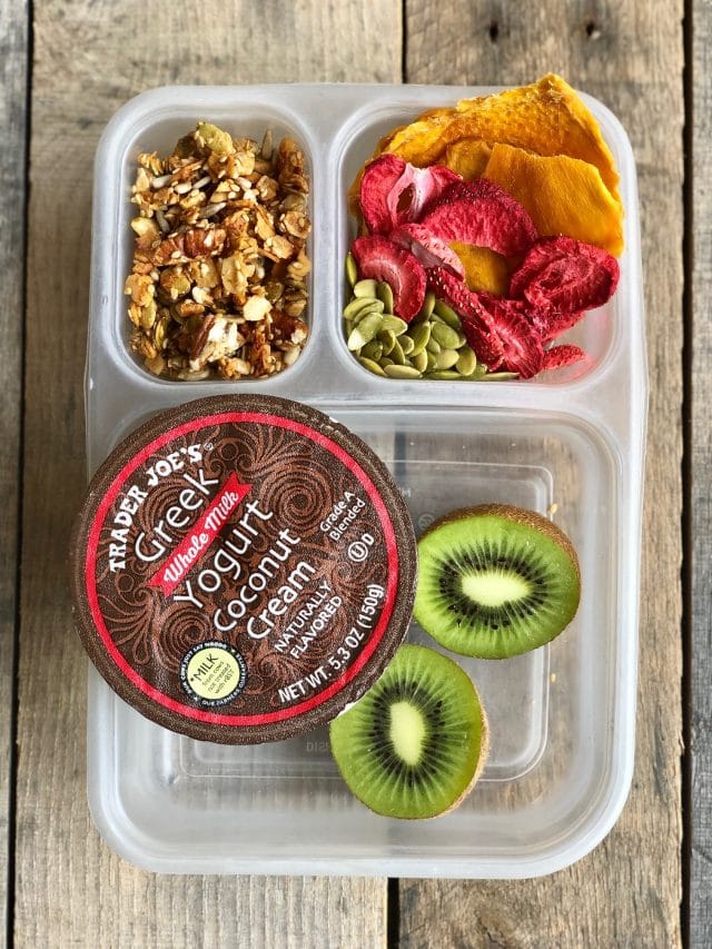 10 Simple School Lunches from Trader Joe's - yogurt, granola, a kiwi, dried mango, freeze dried strawberries and pumpkin seeds. #healthykids #healthykidslunch