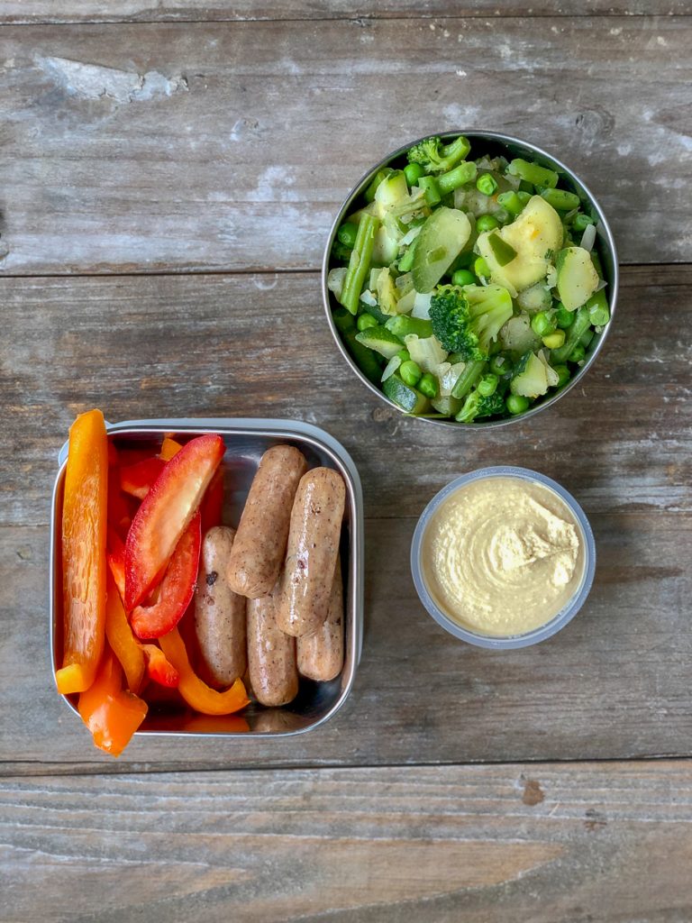 Big mix of mixed greens sauteed with sausage on top. Sliced peppers + hummus