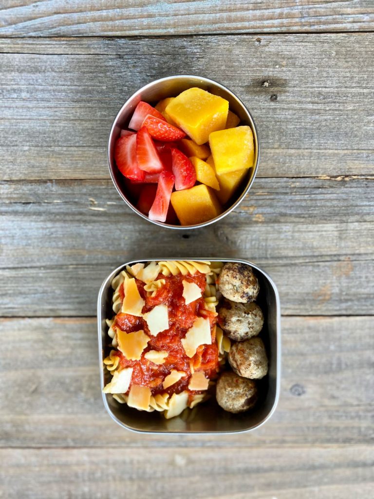 Frozen mango and strawberries, grain-free pasta with sauce, and cheese, Paleo meatballs - a tasty lunch