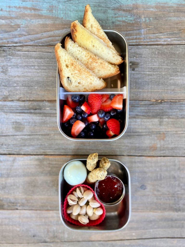 Hard boiled egg, chicken sausage, gluten-free toast, fruit salad, pistachios, jelly school lunch