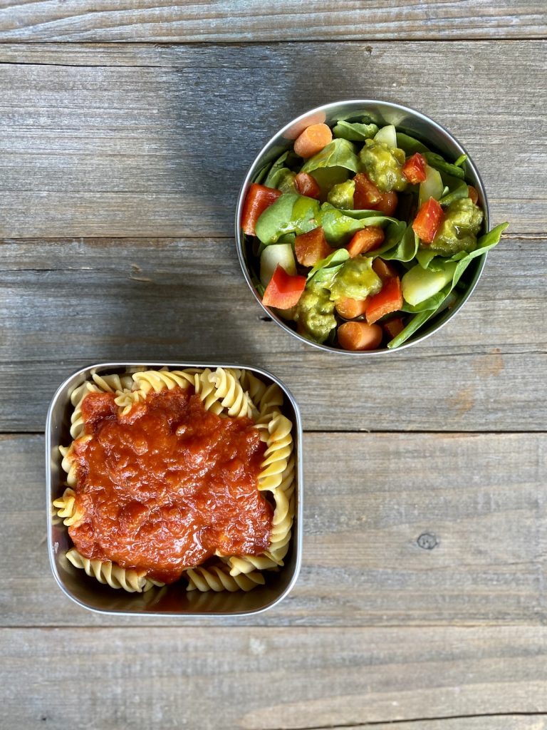 gluten free pasta with marinara, spinach salad with carrots, avocado, pepper, cucumber and honey mustard sauce