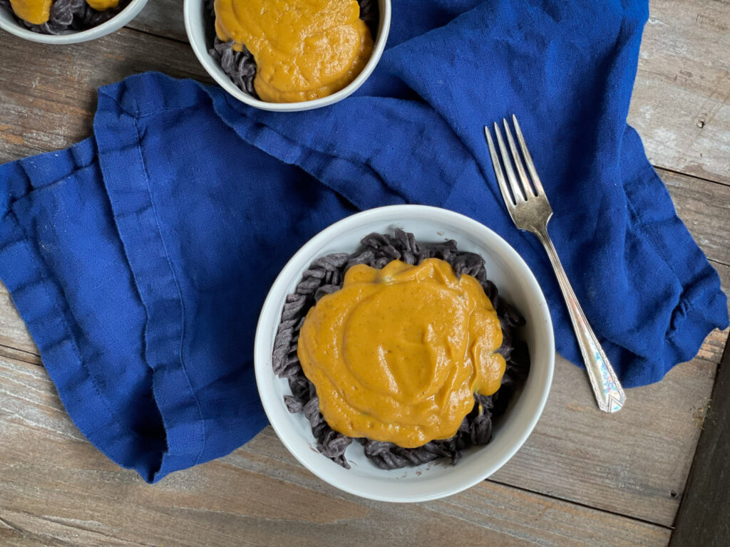 nut free vegan cheese sauce served over black bean pasta