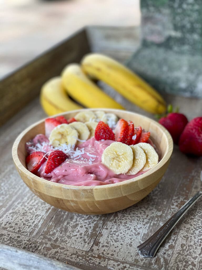 strawberry banana smoothie bowl with toppings