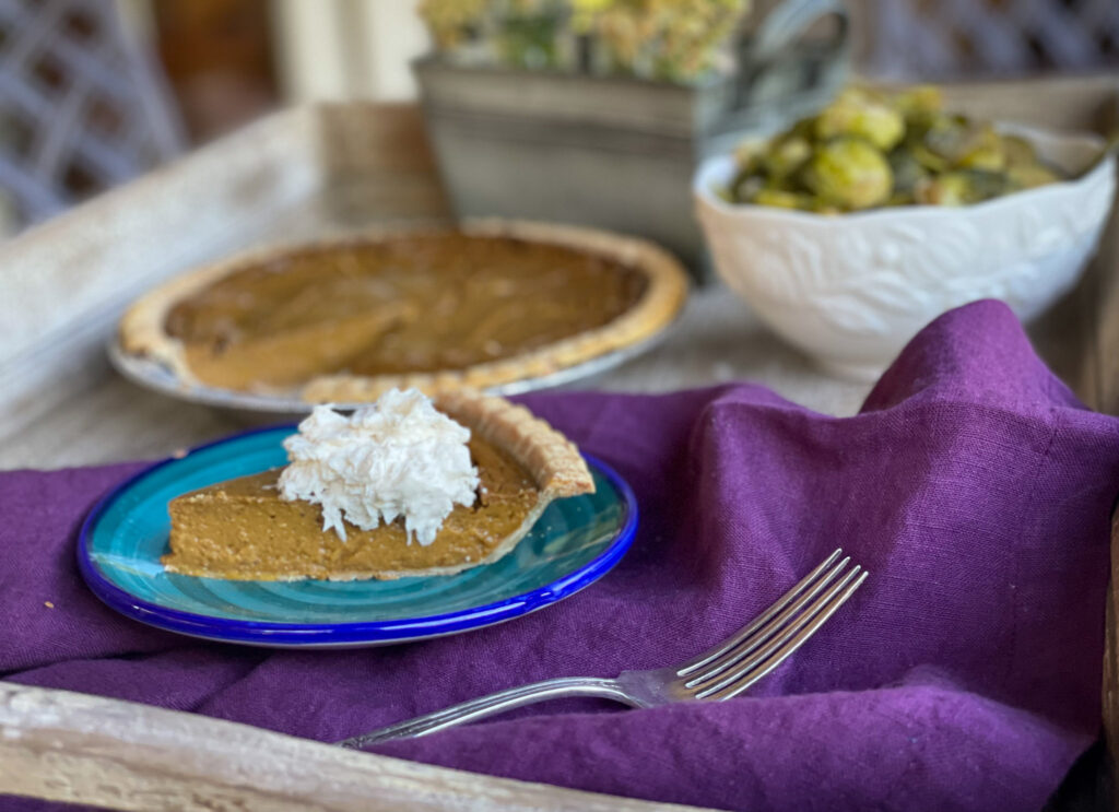 piece of gluten fee dairy free pumpkin pie with dairy free whipped cream