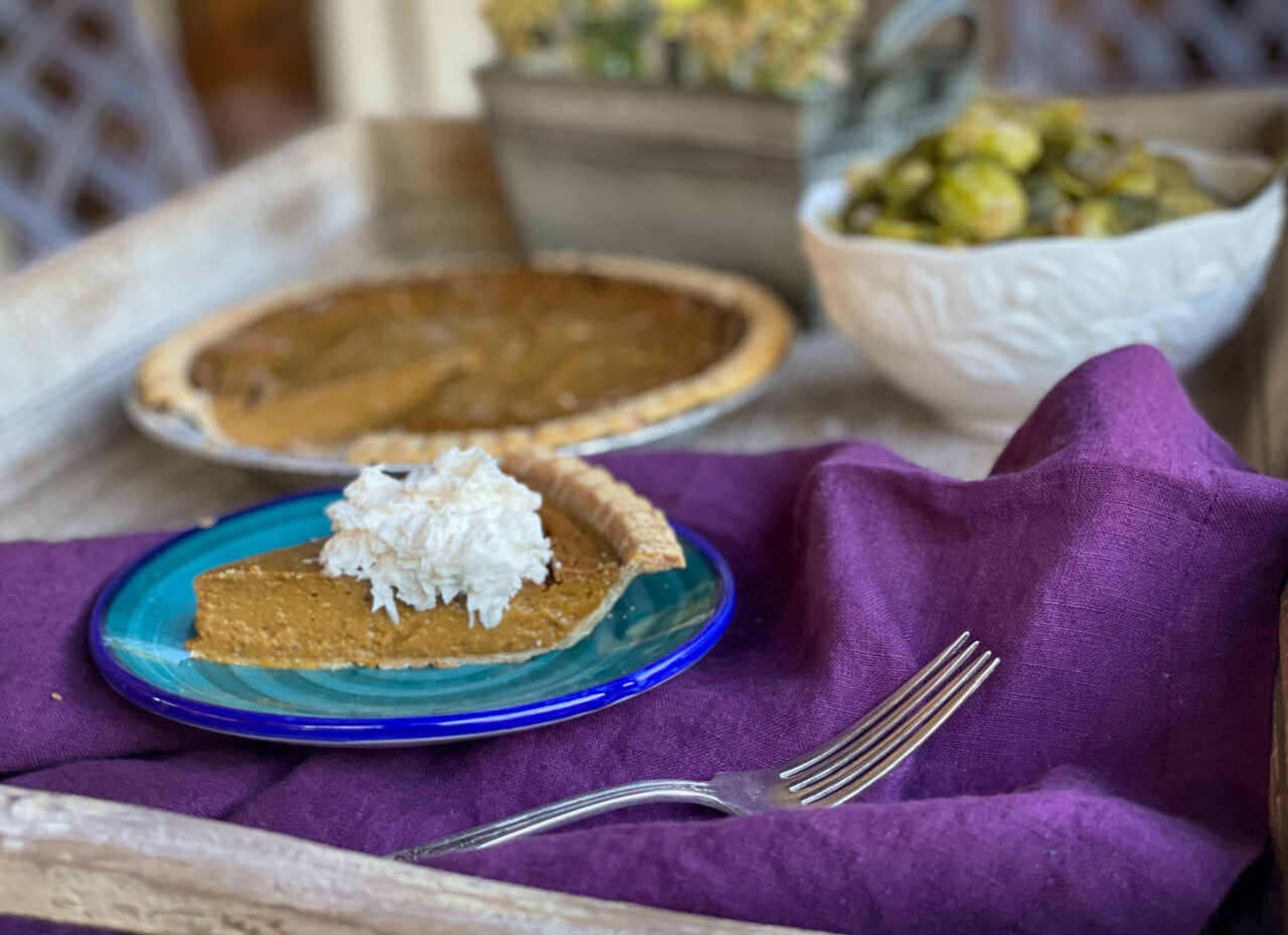 piece of gluten fee dairy free pumpkin pie with dairy free whipped cream